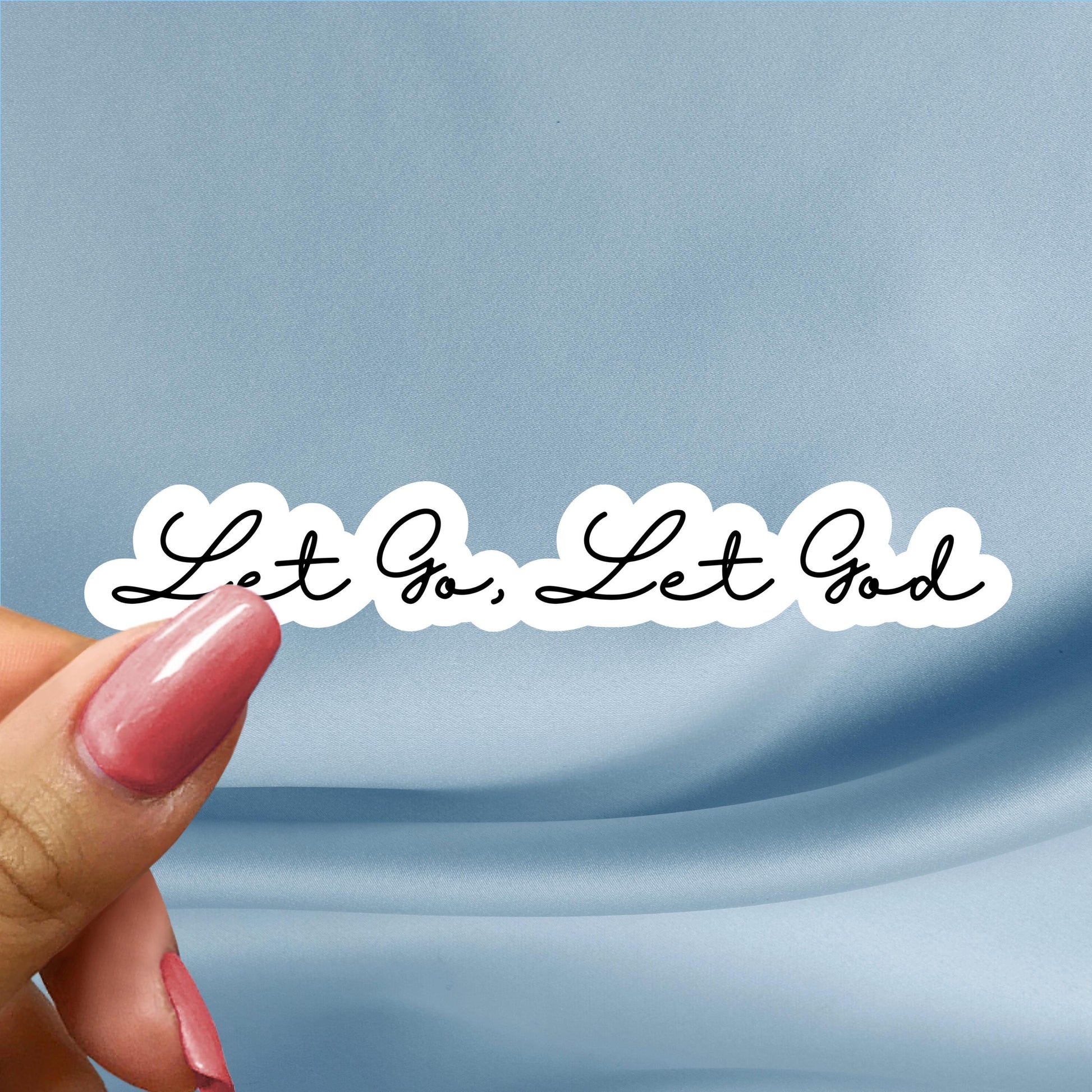 a hand holding a piece of paper with writing on it